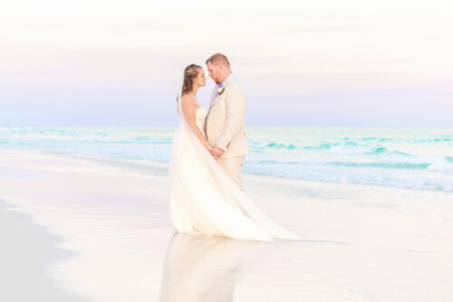 Wedding couple posing for wedding pictures in the beach